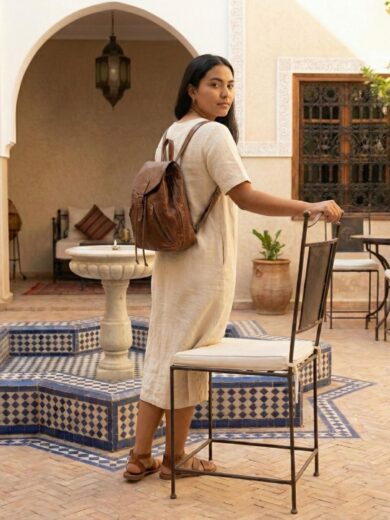 Front view of The Explorer, a Handmade Leather Backpack showing the buckles and pockets.