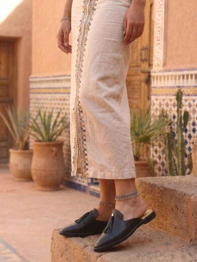 Pair of The Malika, Women's Black Leather Babouche with a pointed toe.