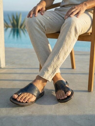 Pair of sleek Men's Black Leather Sandals showing the deep black finish and strap design.