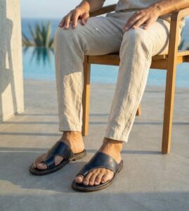Man wearing black Men's Black Leather Sandals styled with LINEN trousers for an evening look.