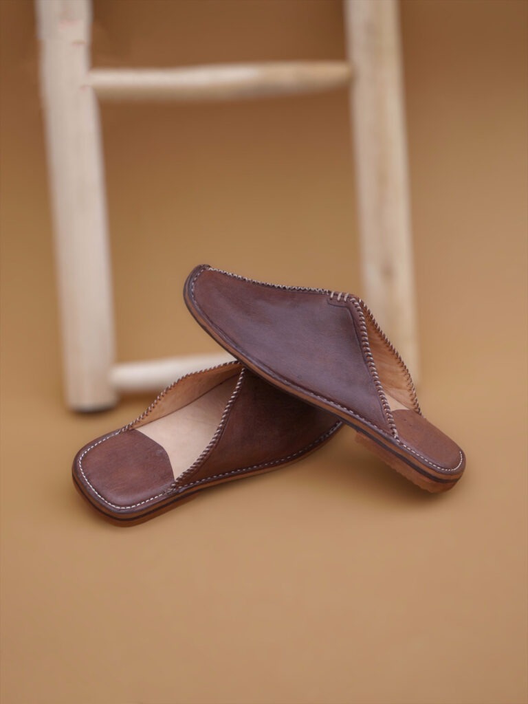 Pair of The Royal, brown Men's Moroccan Leather Slippers with a pointed toe.