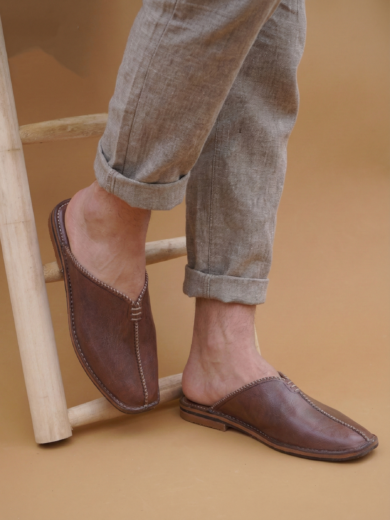 Pair of The Royal, brown Men's Moroccan Leather Slippers with a pointed toe.