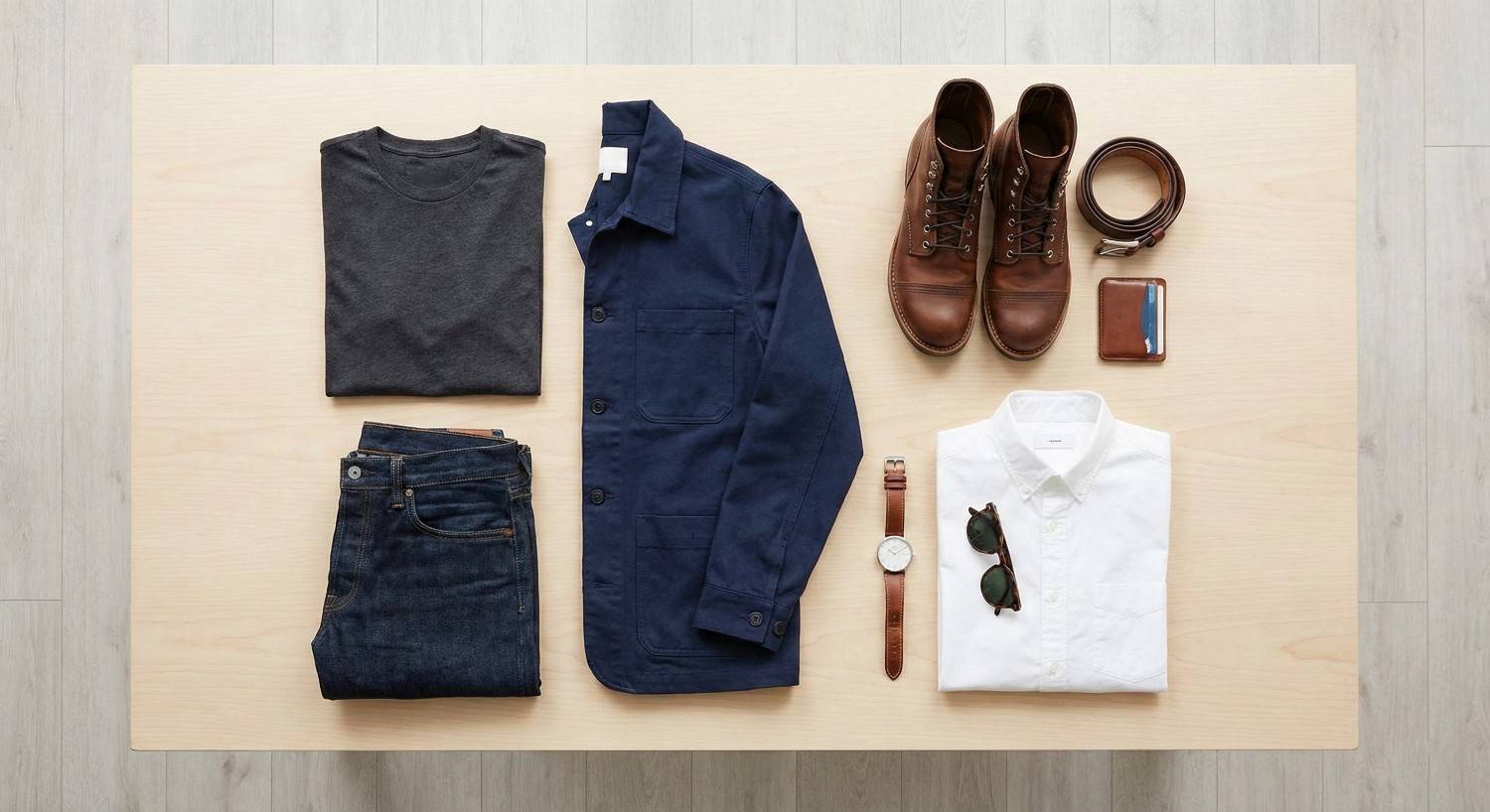 Minimalist men's capsule wardrobe with leather accessories and essential clothing items